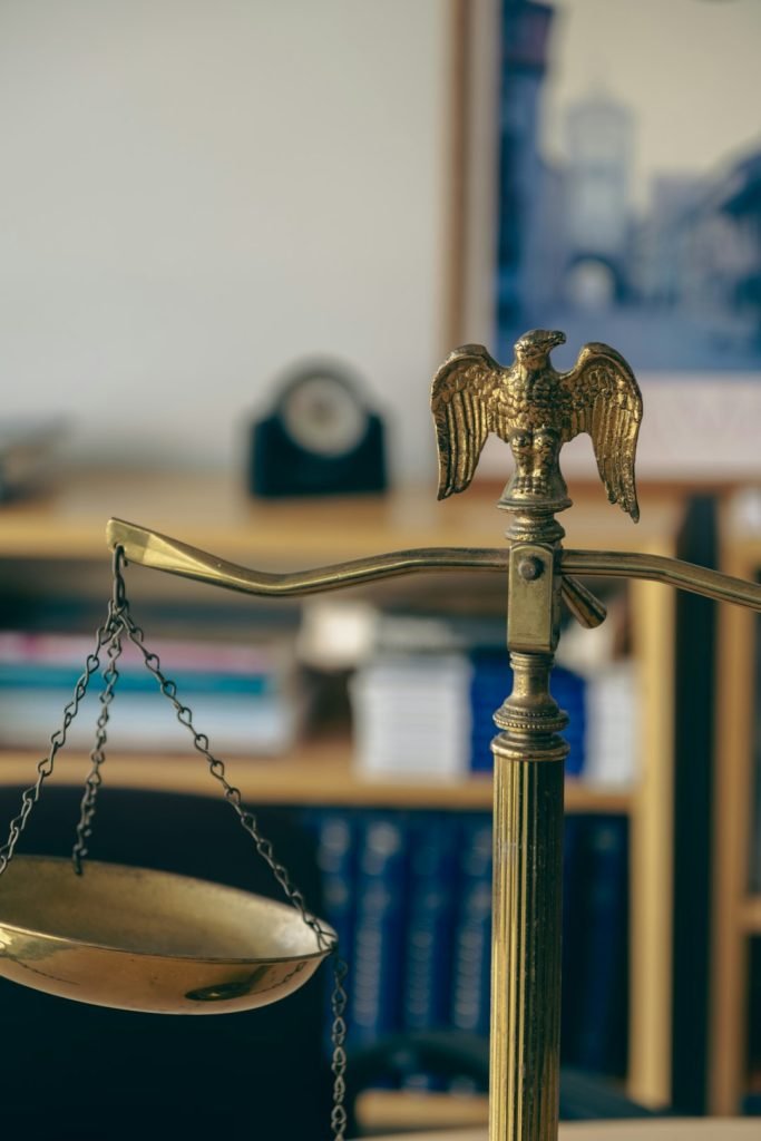 a-golden-scale-with-an-eagle-on-top-of-it-i2ge7blahv4